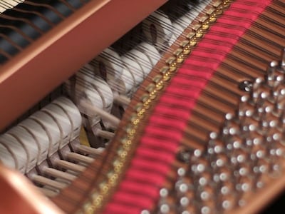 A photo of the inside of grand piano showing